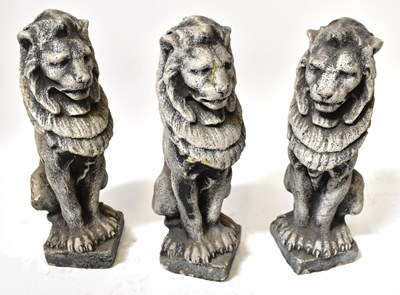 Lot 77 - Three concrete garden statues of seated lions,...