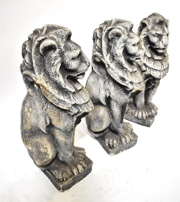 Lot 77 - Three concrete garden statues of seated lions,...