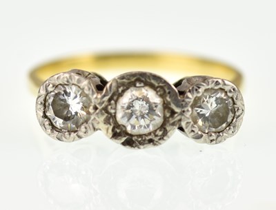 Lot 909 - An 18ct gold three-stone diamond ring, the...