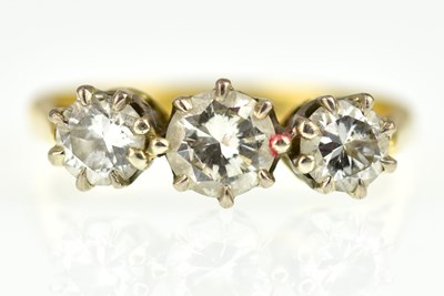 Lot 995 - An 18ct gold ring, the central claw set...