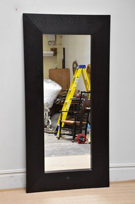 Lot 1036 - A large ebonised modern wall mirror, 190cm x...