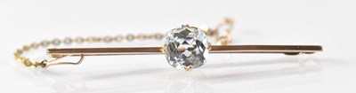 Lot 1061 - A 9ct gold bar brooch with a circular facet...