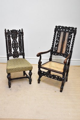 Lot 1195 - A Carolean style carved oak elbow chair with...