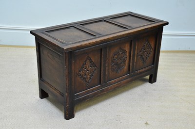 Lot 1075 - A reproduction carved oak coffer of small...