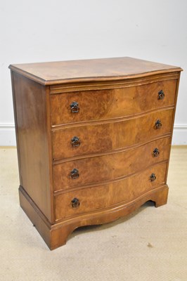 Lot 1116 - A 1950s walnut serpentine fronted chest of...