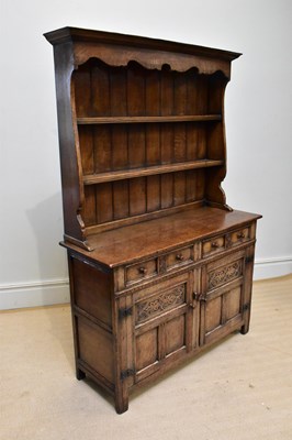 Lot 1068 - A reproduction oak dresser with boarded plate...