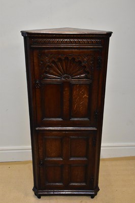 Lot 1074 - A reproduction carved oak freestanding corner...