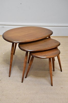 Lot 1016 - ERCOL; a medium elm nest of three graduated...