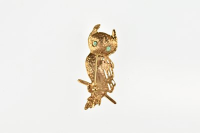 Lot 1064 - A 9ct gold owl brooch with emerald eyes,...
