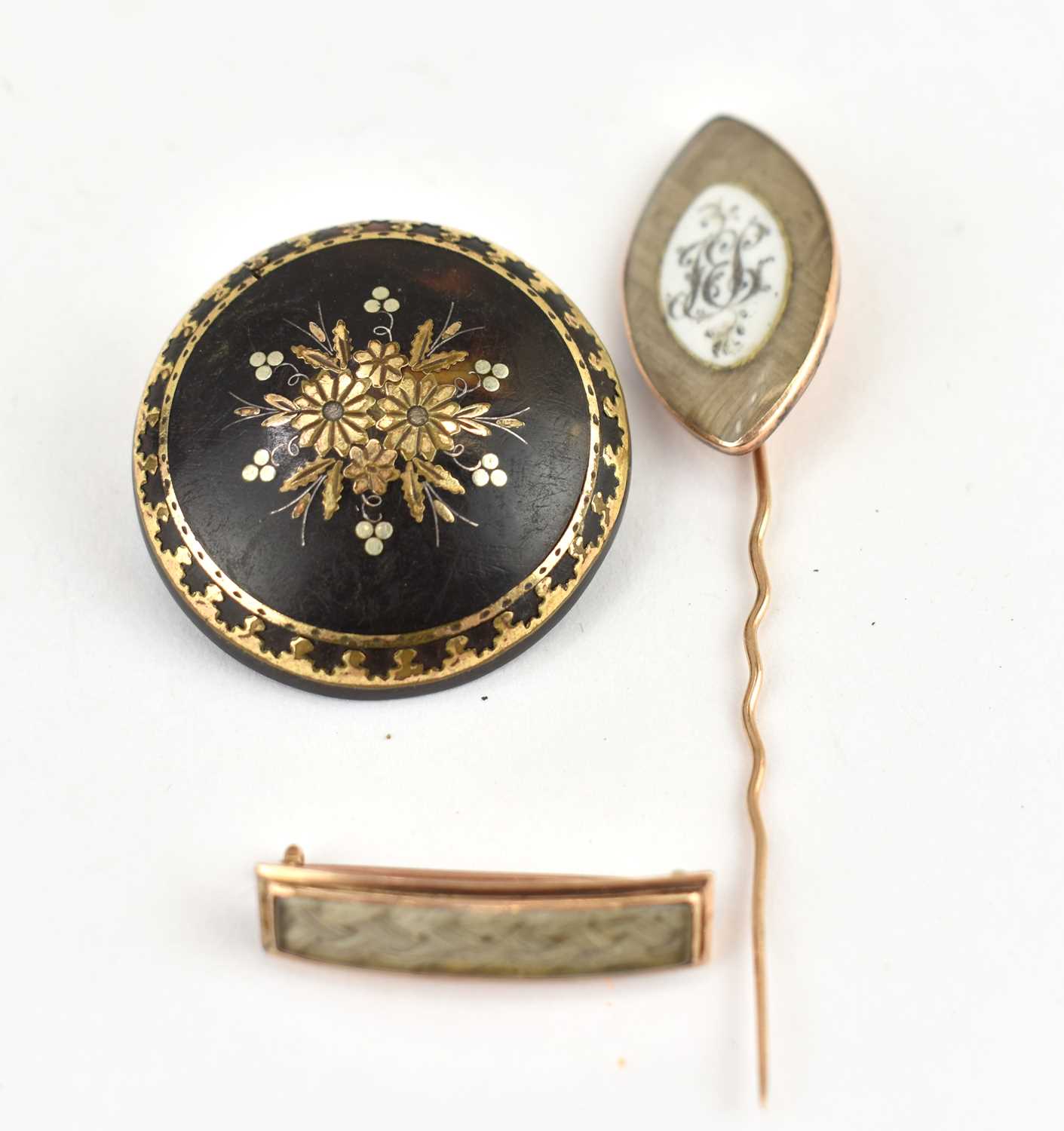 Lot 1067 - Three early 19th century mourning brooches,...