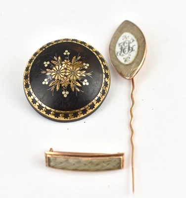 Lot 1067 - Three early 19th century mourning brooches,...
