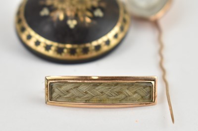 Lot 1067 - Three early 19th century mourning brooches,...