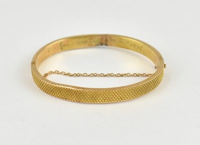 Lot 1035 - A 15ct gold hinged bracelet with cross-hatched...