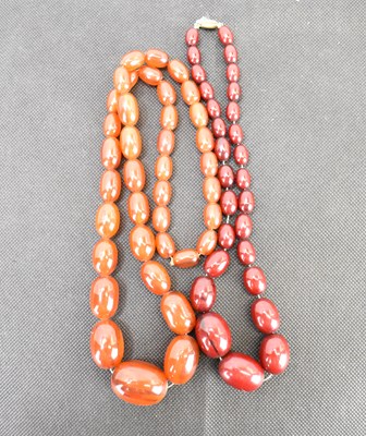 Lot 1099 - Two graduated amber-style necklaces, one of...