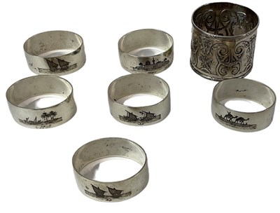 Lot 1172 - A set of six white metal napkin rings with...