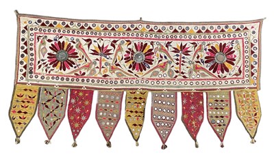 Lot 561 - An Indian Toran wall hanging, embroidered in...