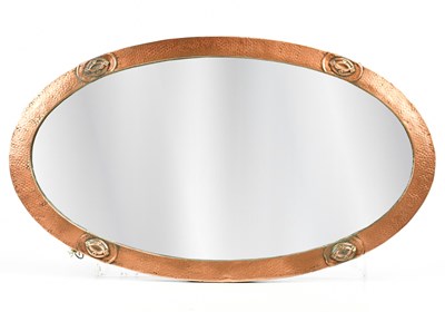 Lot 1035 - An Arts & Crafts hammered copper framed oval...