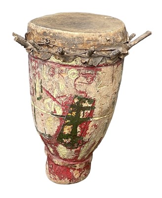 Lot 559 - An African wooden drum with carved and painted...