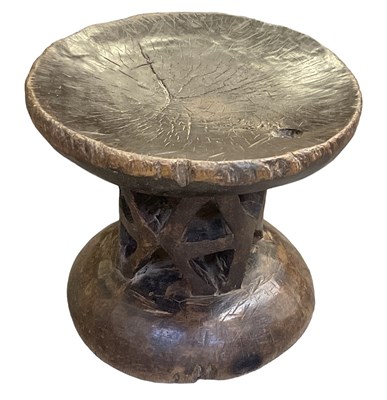 Lot 1083 - An African carved hardwood stool, width 31cm.