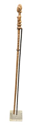 Lot 1087 - An African carved wooden baton with ribbed...