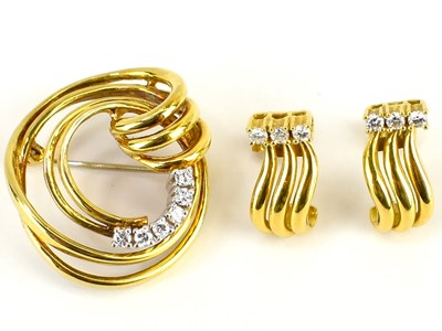 Lot 1058 - A 14ct gold brooch of swirl design, with six...
