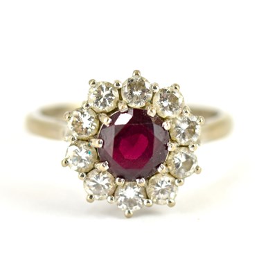 Lot 1006 - An 18ct white gold ring with claw set central...