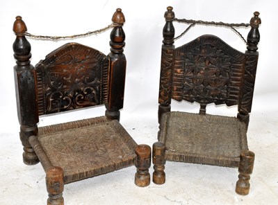 Lot 1510 - Two similar stained wood chairs, with carved...