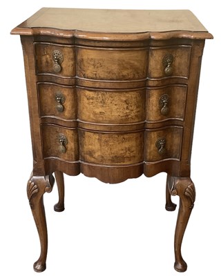 Lot 66 - A 1930s walnut three drawer bedside table on...