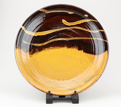 Lot 104 - CLIVE BOWEN (born 1943); a slipware charger...