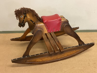 Lot 247 - A vintage wooden rocking horse with red...