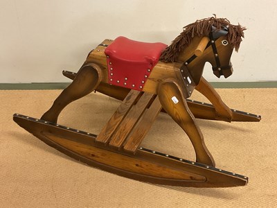 Lot 247 - A vintage wooden rocking horse with red...