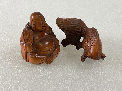 Lot 272 - Two boxwood netsuke carved as a Buddha and a...