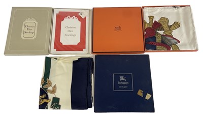 Lot 513 - HERMÈS; a 100% silk scarf, a Burberry silk...