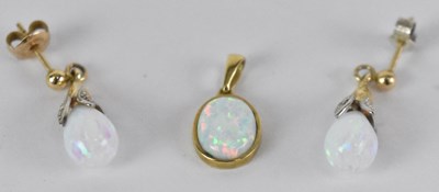 Lot 1315 - A pair of 9ct yellow gold opal earrings with...