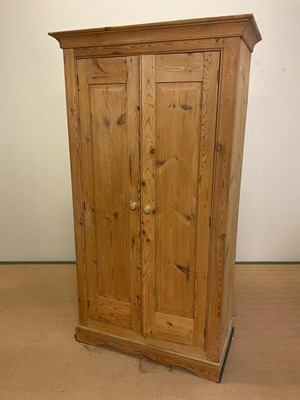 Lot 745 - A rustic pine double wardrobe with single...