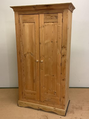 Lot 746 - A rustic pine double wardrobe with single...