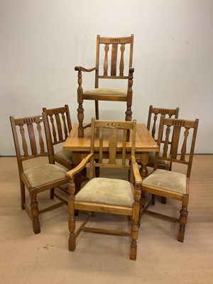 Lot 771 - A light oak extending dining table, with four...