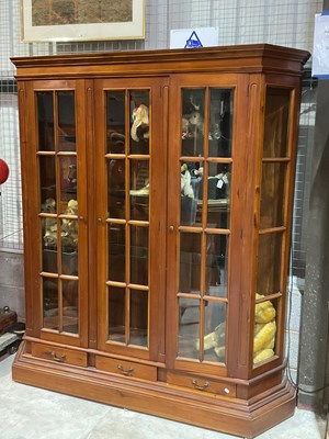 Lot 808 - A mahogany triple door glass panelled cabinet,...