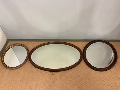 Lot 782 - Three oval mirrors, with wooden surrounds, one...