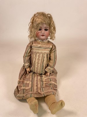 Lot 166 - SIMON & HALBIG; a bisque head doll with brown...