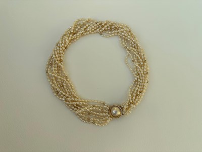 Lot 7 - A seed pearl and gold tone choker, with a...