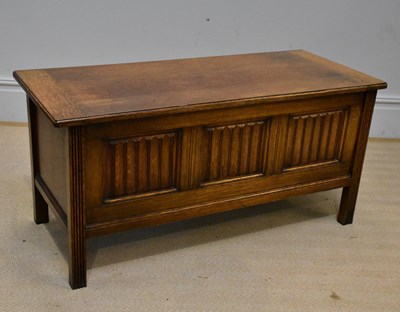 Lot 1077 - An reproduction oak blanket box on square legs,...