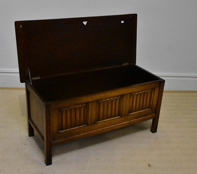 Lot 1077 - An reproduction oak blanket box on square legs,...