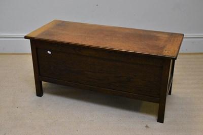 Lot 1077 - An reproduction oak blanket box on square legs,...