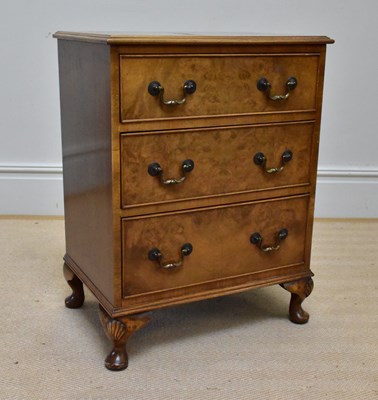 Lot 1115 - A reproduction walnut three drawer chest,...