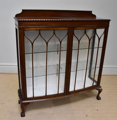 Lot 1245 - An early 20th century display cabinet on ball...