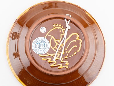 Lot 416 - MARY WONDRAUSCH (1923-2016); a slipware plate...