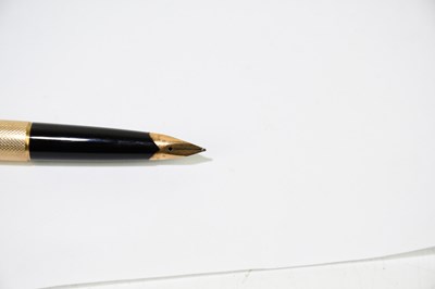 Lot 62 - PARKER; a 9ct gold cased fountain pen with 14K...
