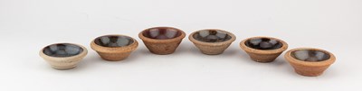 Lot 64 - Leach Pottery; a set of six stoneware pin...