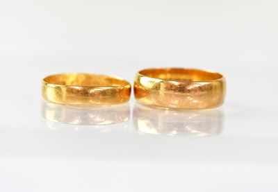 Lot 918 - Two 22ct gold wedding bands, size K and size L,...